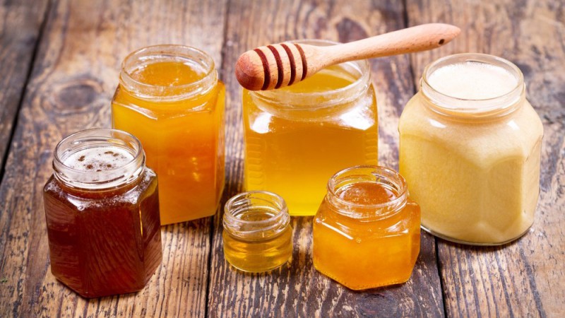 various types of honey in glass jars